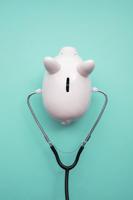 Cost Of Healthcare. Piggy Bank Money Box With A Medical Doctors Stethoscope