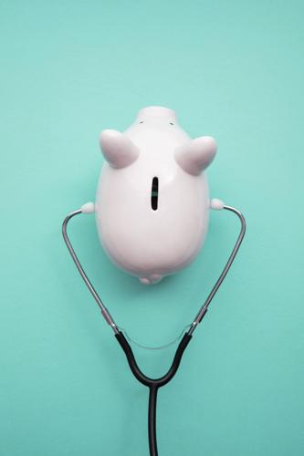 Cost Of Healthcare. Piggy Bank Money Box With A Medical Doctors Stethoscope