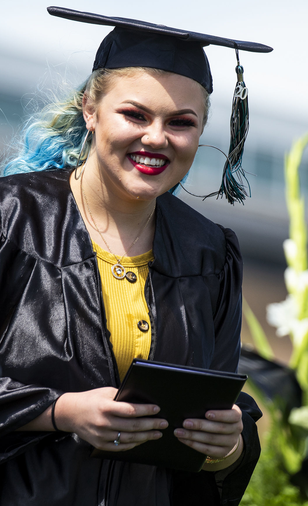 Westwood High School graduates turn their tassels in unison Friday