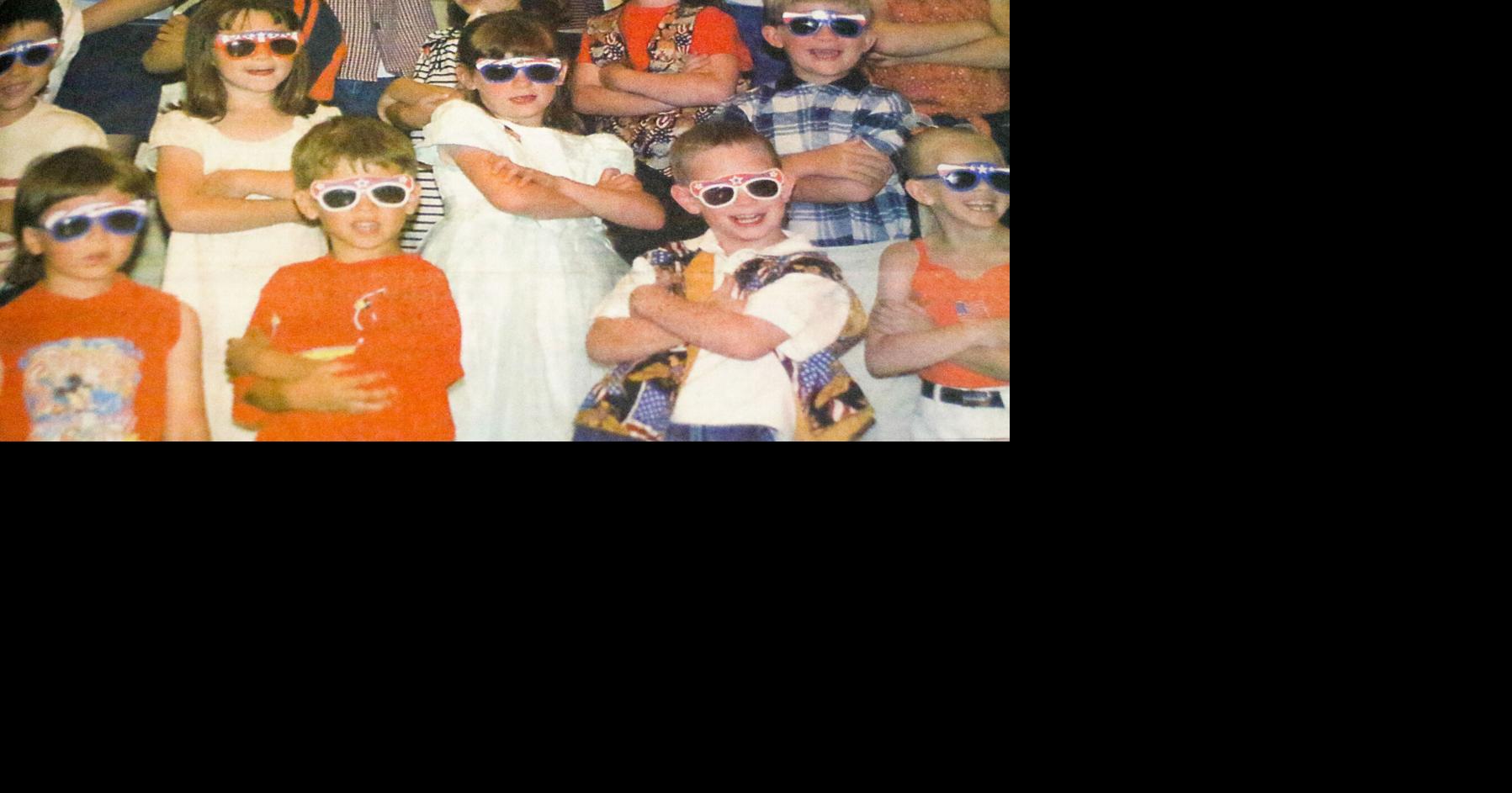 Histories: Kindergartners pose while singing during 2003 school performance