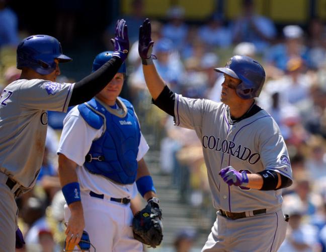 Colorado Rockies' Todd Helton (17) is congratulated by teammate