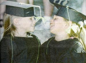 Histories: Girls enjoy moment together during preschool graduation in 1997