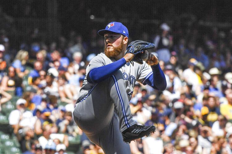 Milwaukee Brewers' Willy Adames, right, celebrates after his base hit  during the eighth inning of a baseball game against the Toronto Blue Jays,  Sunday, June 26, 2022, in Milwaukee. (AP Photo/Kenny Yoo