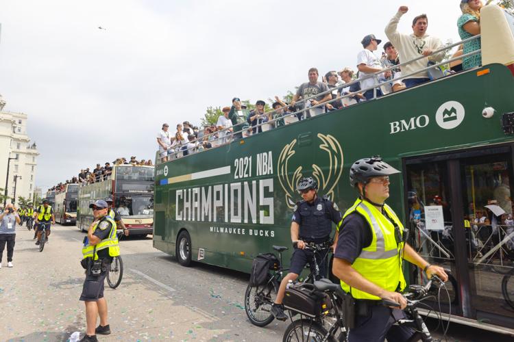 Milwaukee Bucks' Giannis Antetokounmpo holds up the NBA Championship trophy  and Finals MVP trophy to the crowd during a parade celebrating the  Milwaukee Bucks' NBA Championship basketball team Thursday, July 22, 2021
