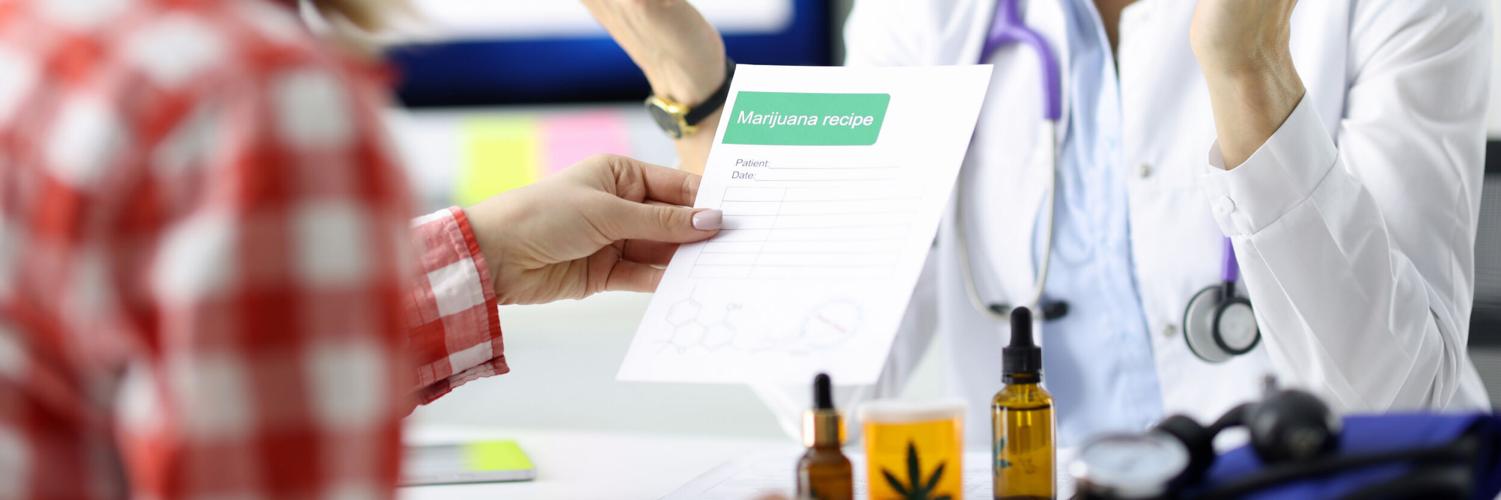 GettyImg.Doctor giving patient prescription for drug in clinic