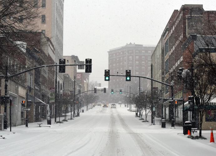 Crews work to clear roads after nearly 9 inches of snow, sleet falls in