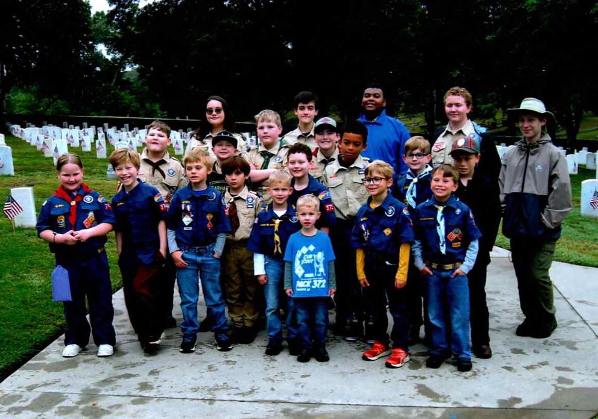 Scouts place flags on graves at Danville National Cemetery