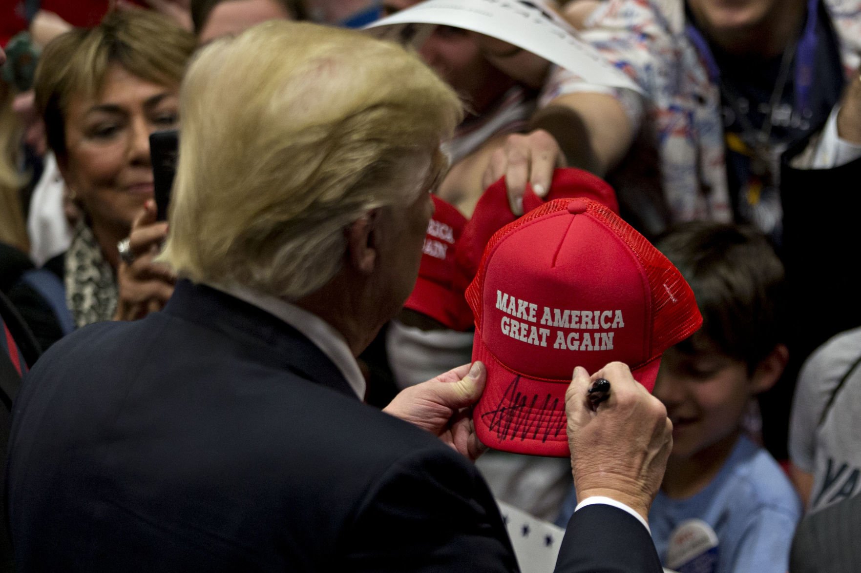 Trump sales signing hats