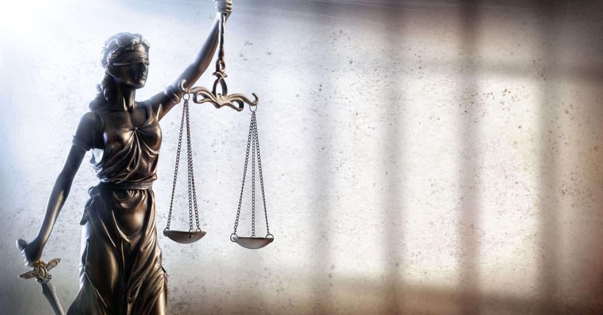 Lady Justice Statue With Shadow Of Prison Bars