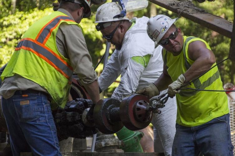 Workers perform maintenance on a natural gas pipeline.