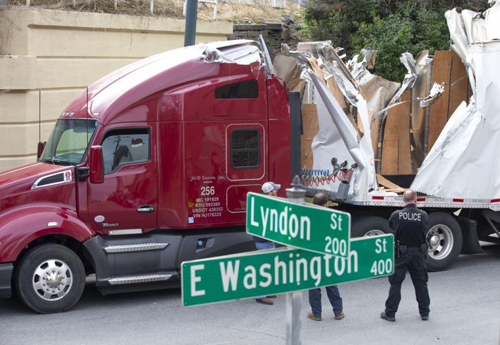 Truck runs into bridge