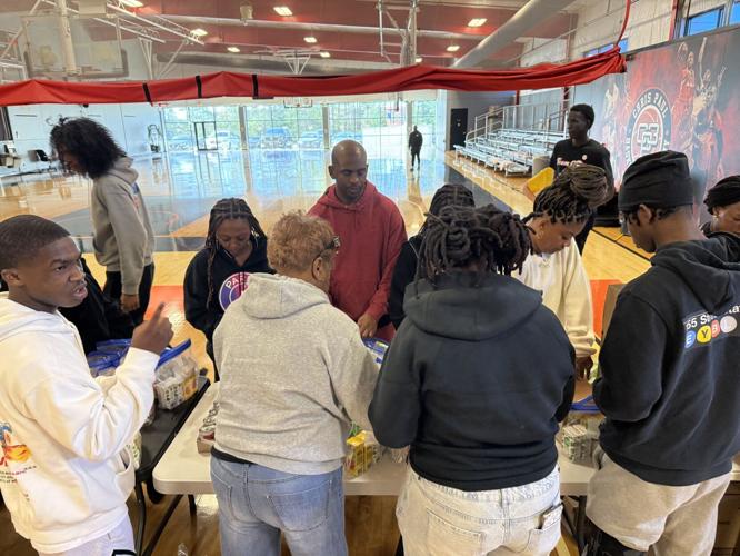 Chris Paul helps pack food for Forsyth Backpack Program