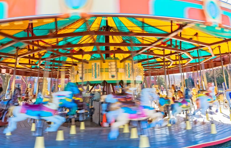 Colorful carousel in rotation in Washington DC public park. WASHINGTON, USA: Colorful carousel in rotation in National Mall park.
