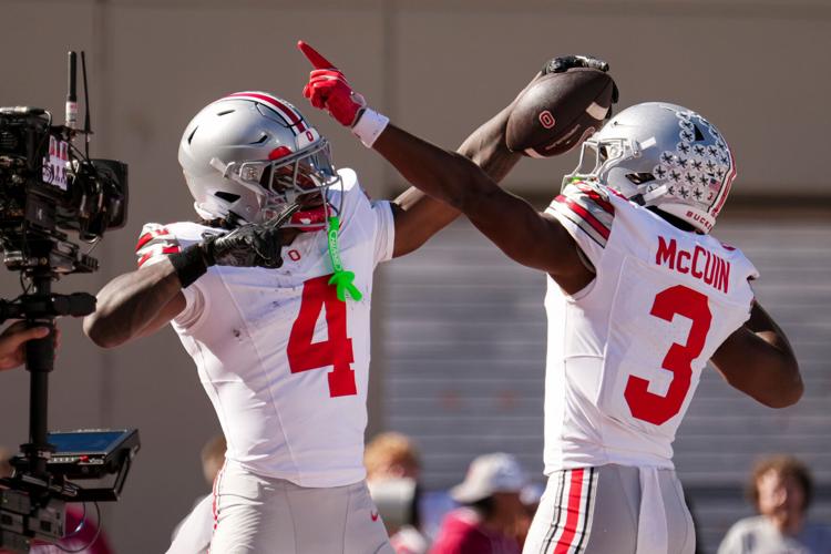 Ohio State Buckeyes wide receiver Jeremiah Smith (4) celebrates a touchdown with with wide receiver Devin McCuin (3) during the