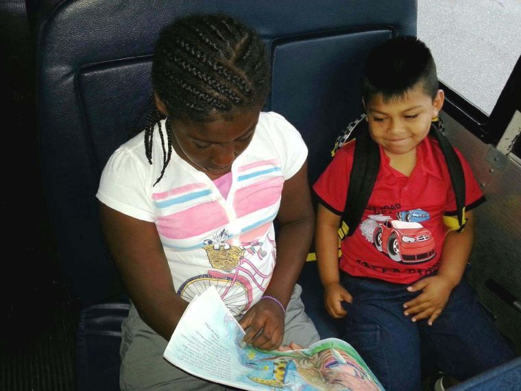 Students read while riding bus