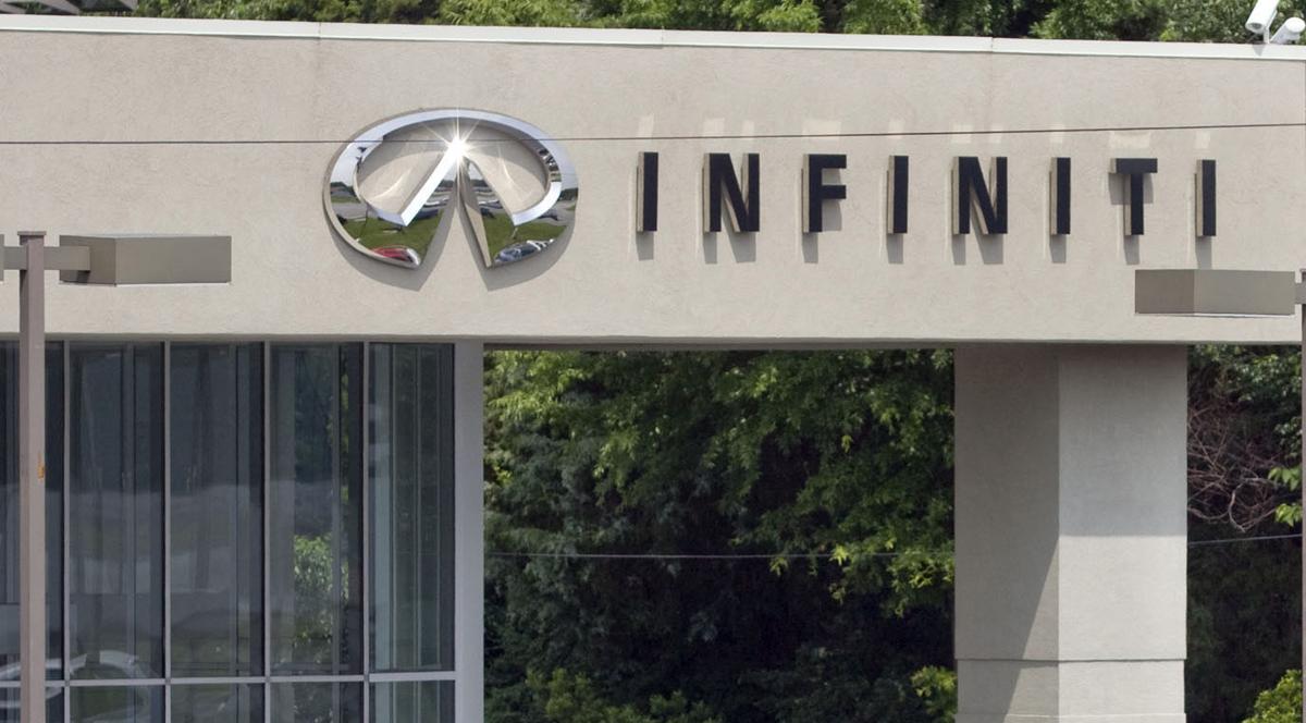 Signage is posted on the side of vehicles outside of Modern Infiniti on University Parkway
