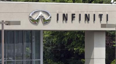 Signage is posted on the side of vehicles outside of Modern Infiniti on University Parkway