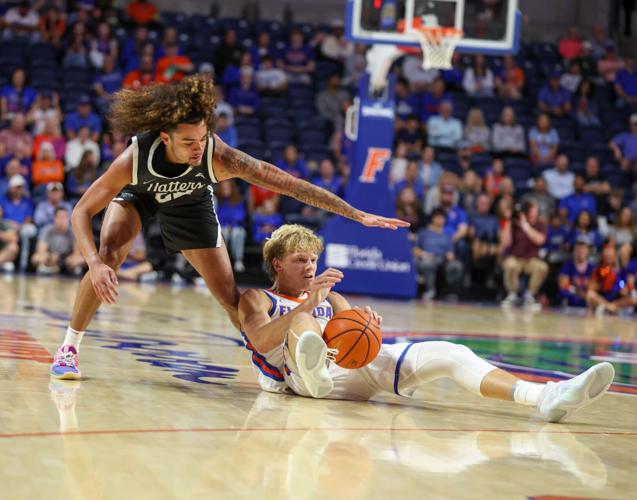 Florida Thomas Haugh (10) steals the ball from Stetson Roman Miller (23) during the second half of an NCAA exhibition basketball