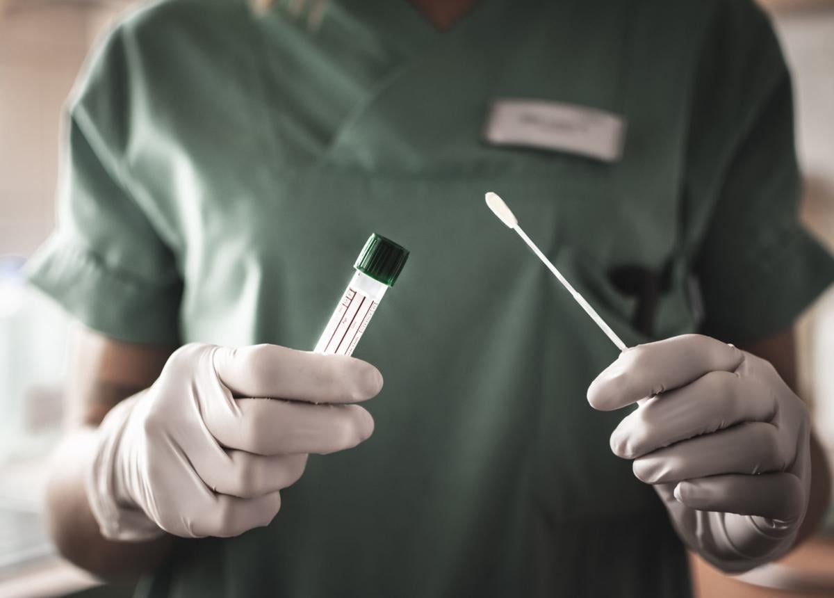 nurse holds a swab for the coronavirus (copy) (copy)