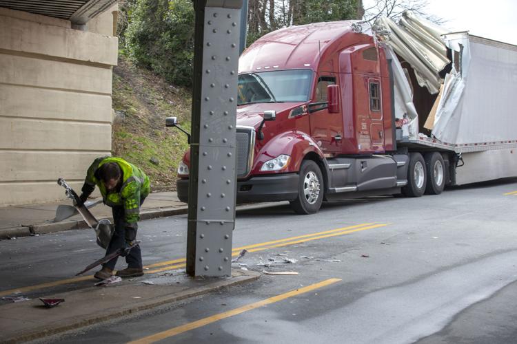 Truck runs into bridge