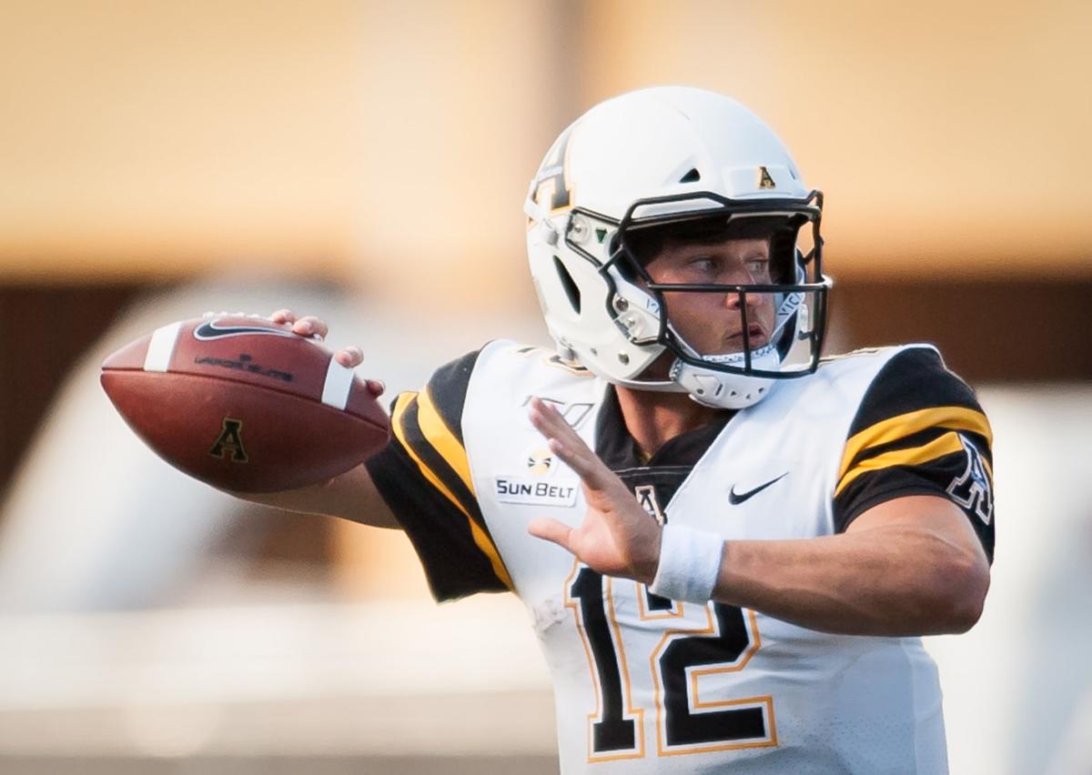 Appalachian State coach Eliah Drinkwitz talks with quarterback Zac Thomas  (12) during the second half of the team's NCAA college football game  against Troy on Friday, Nov. 29, 2019, in Troy, Ala. (