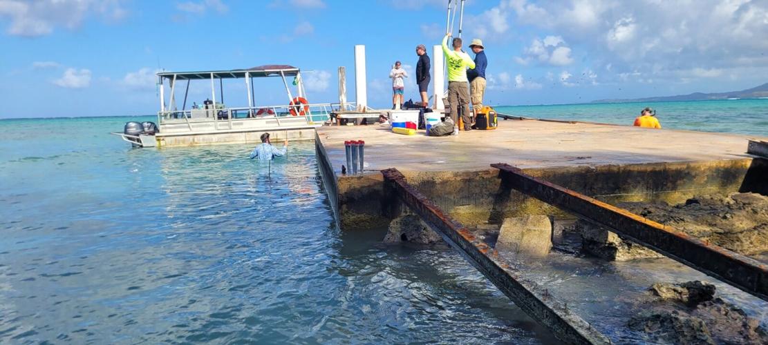 Scientists remove contaminated debris from Cocos, update residents on