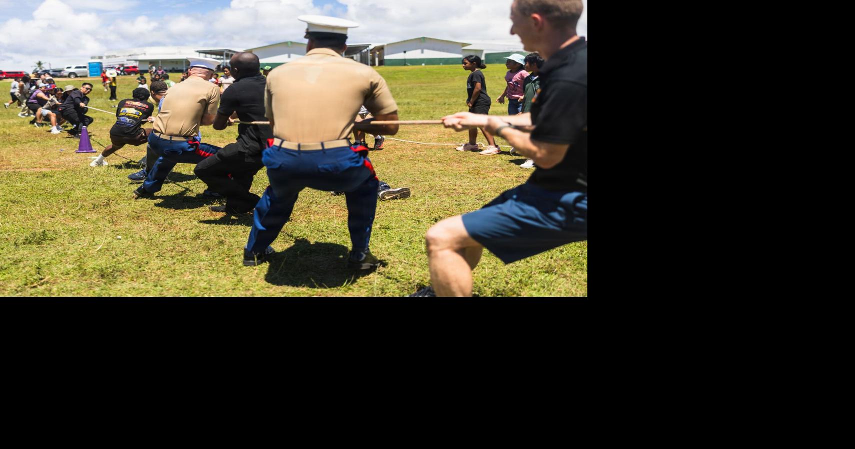 Camp Blaz Marines join Finegayan Elementary's Mes CHamoru event, donate sports equipment