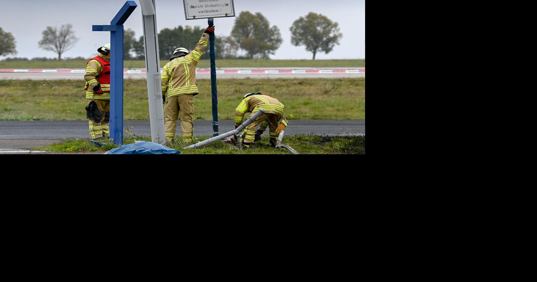German authorities investigate a hole cut into a fence at Leipzig ...