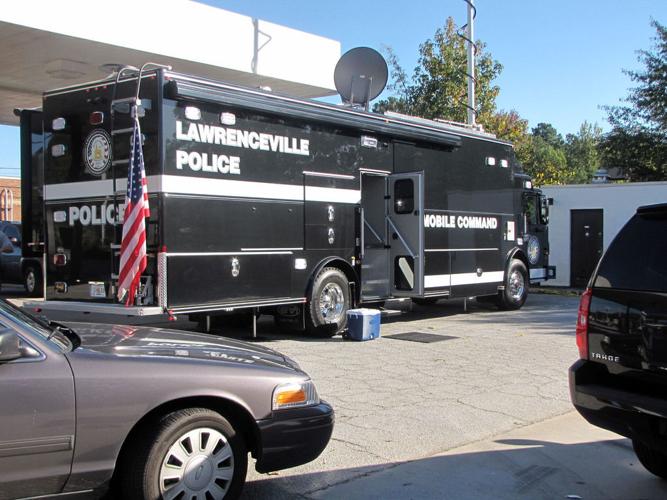 Foul play suspected after body found behind Lawrenceville oil change