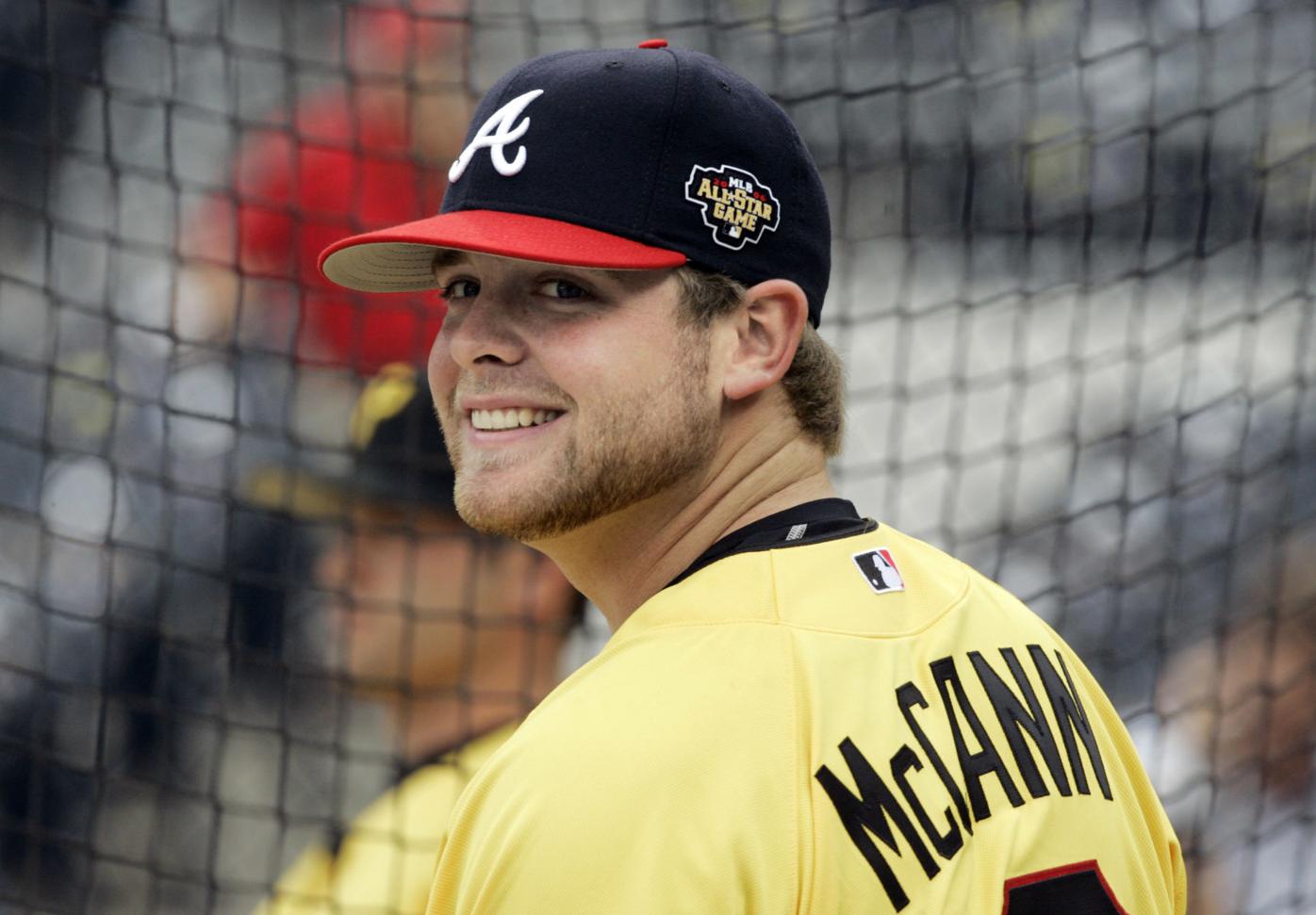 Atlanta Braves - Brian McCann celebrates in the dugout after his