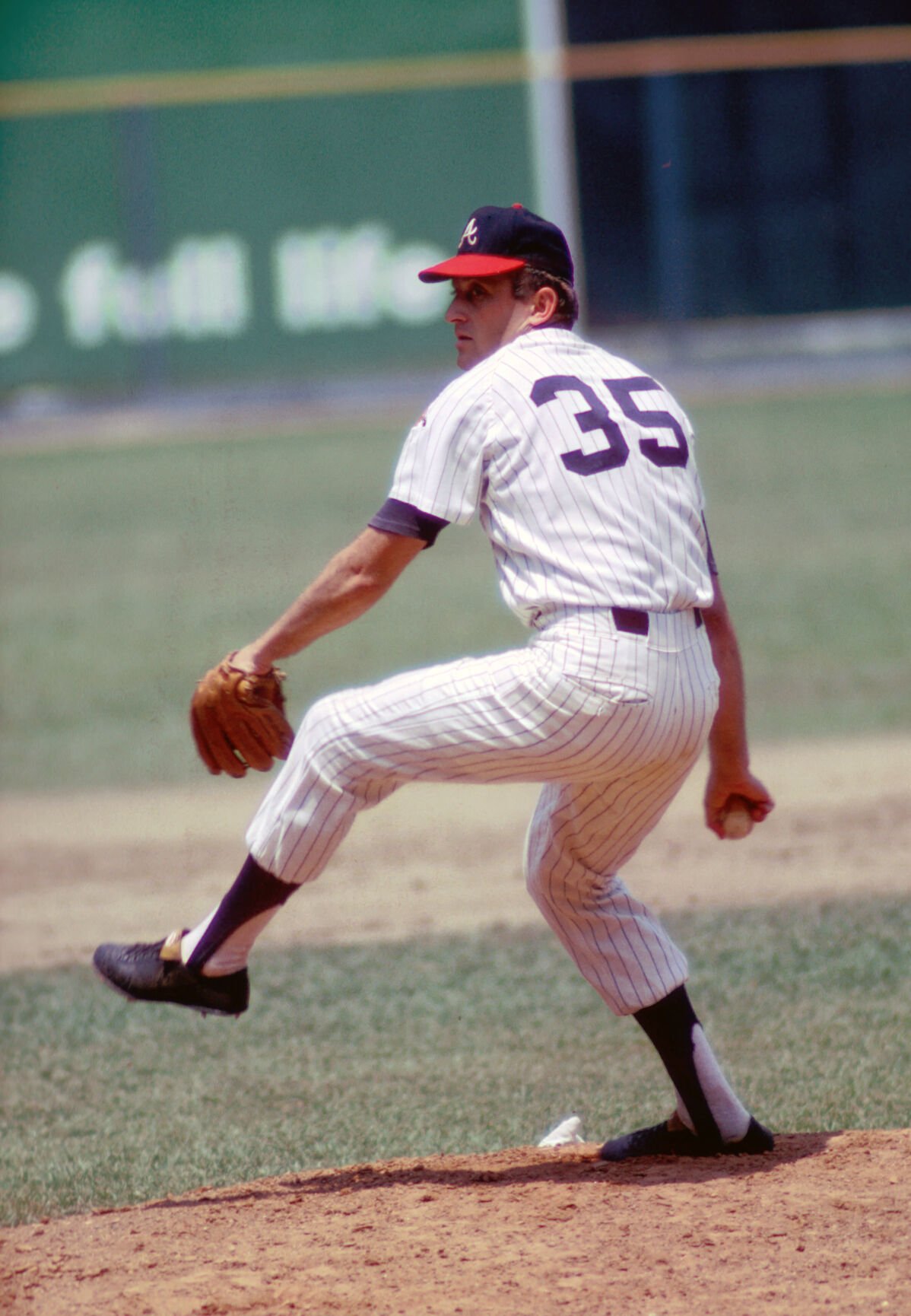 Former Atlanta Braves pitcher Phil Niekro throws out a pitch while