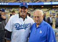 In this March 31, 2011, photo, former Los Angeles Dodgers manager Tommy  Lasorda, right, stands with former pitcher Fernando Valenzuela before a  baseball game at Dodger Stadium in Los Angeles. Lasorda, the