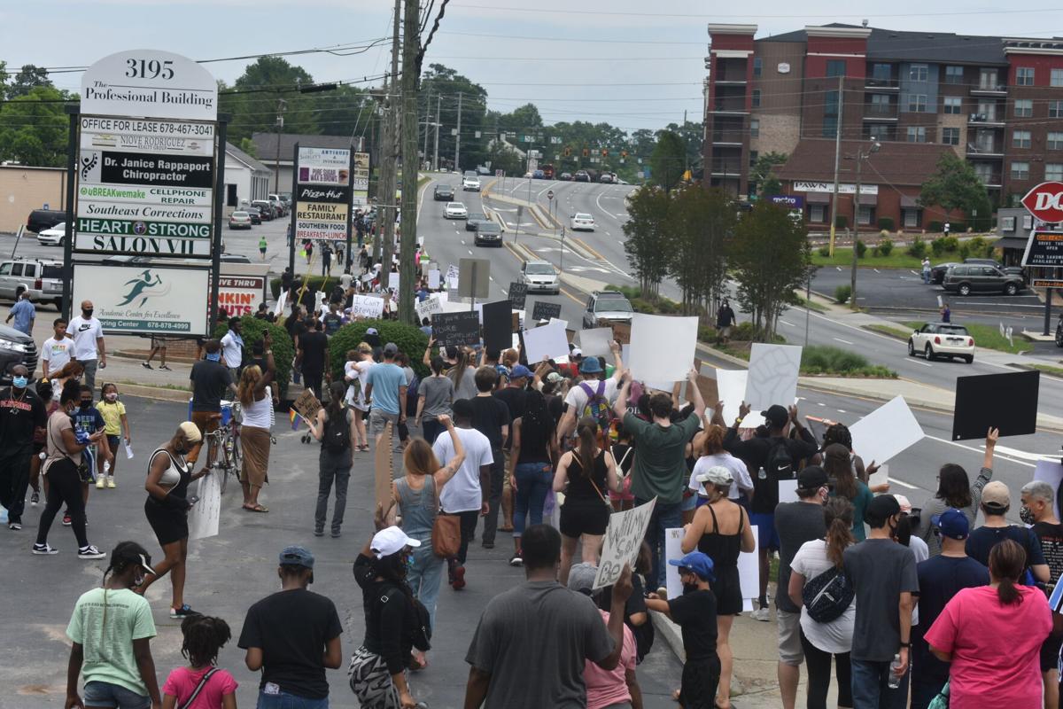 Photos Demonstrators March Against Excessive Police Force In Downtown Duluth News Gwinnettdailypost Com