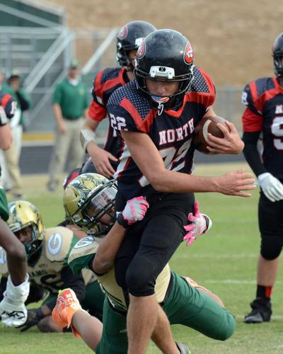 North Gwinnett running back Cade Edwards (22) tries to break a tackle by  Grayson defender Jaden Smith (27) in 8th Grade Division 2 GFL Championship  action. (Photo: Jamie Akoubian)