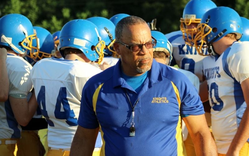 Northeast Baptist assistant coach Horace Charles (Blue Shirt) patrols the sidelines