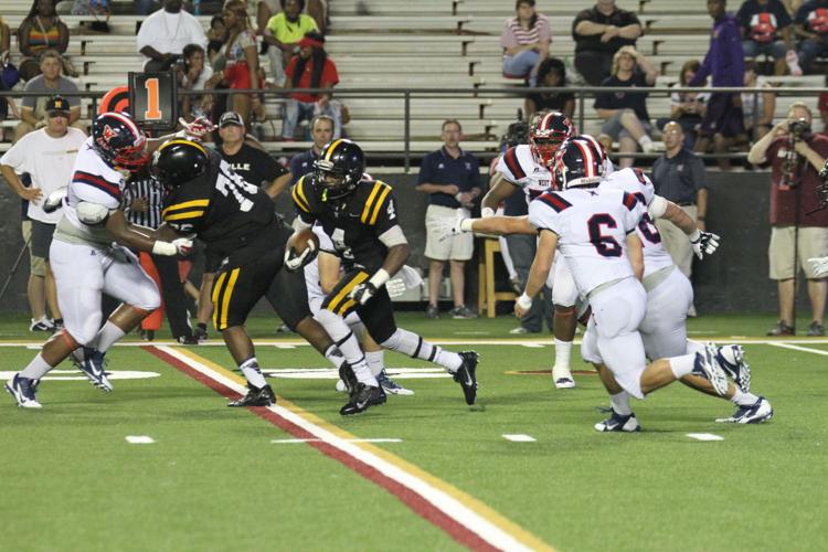 Neville senior Kavontae Turpin (#4) rushes for a first down