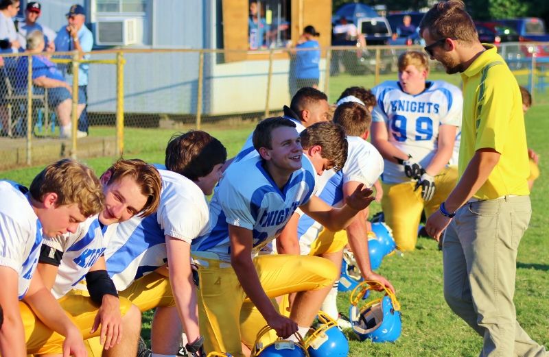 Northeast Baptist head coach Tyler Albritton (Yellow Shirt) shares a laugh with his players