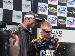 Veteran NASCAR driver Jeff Burton takes wide receiver Chad Ochocinco on test ride around AMS