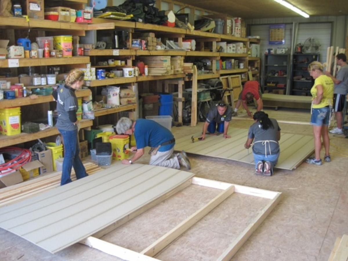 Gallery EY of Charleston volunteers help at Habitat News herald