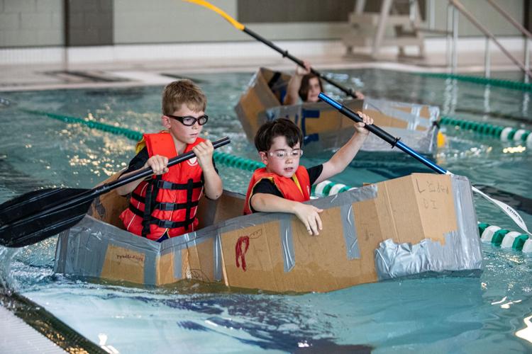 Children test engineering skills in KidsFest cardboard boat race