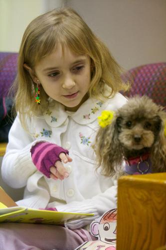 Children read to therapy dogs as part of library program | News ...