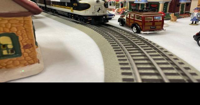Gallery adds window display with Christmas village, train set