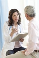 Doctor Discussing With Patient In Clinic
