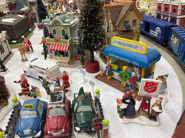 Gallery adds window display with Christmas village, train set