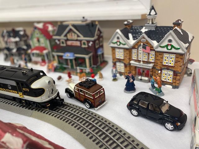 Gallery adds window display with Christmas village, train set