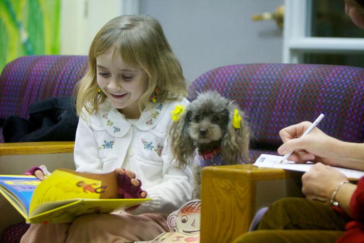 Children read to therapy dogs as part of library program | News ...