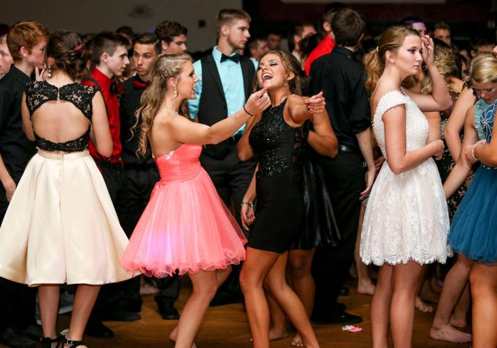 Students dressed in formal attire at college homecoming dance