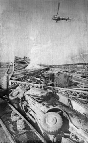 A helicopter hovering over the wreckage of the Sliver Bridge disaster.