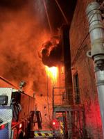 Firefighters work to contain blaze in empty building
