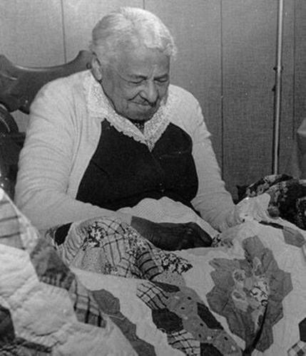 Callie J. Barnett with quilts, Location and date unknown Notan Studios Collection (Barnett, Callie J.)